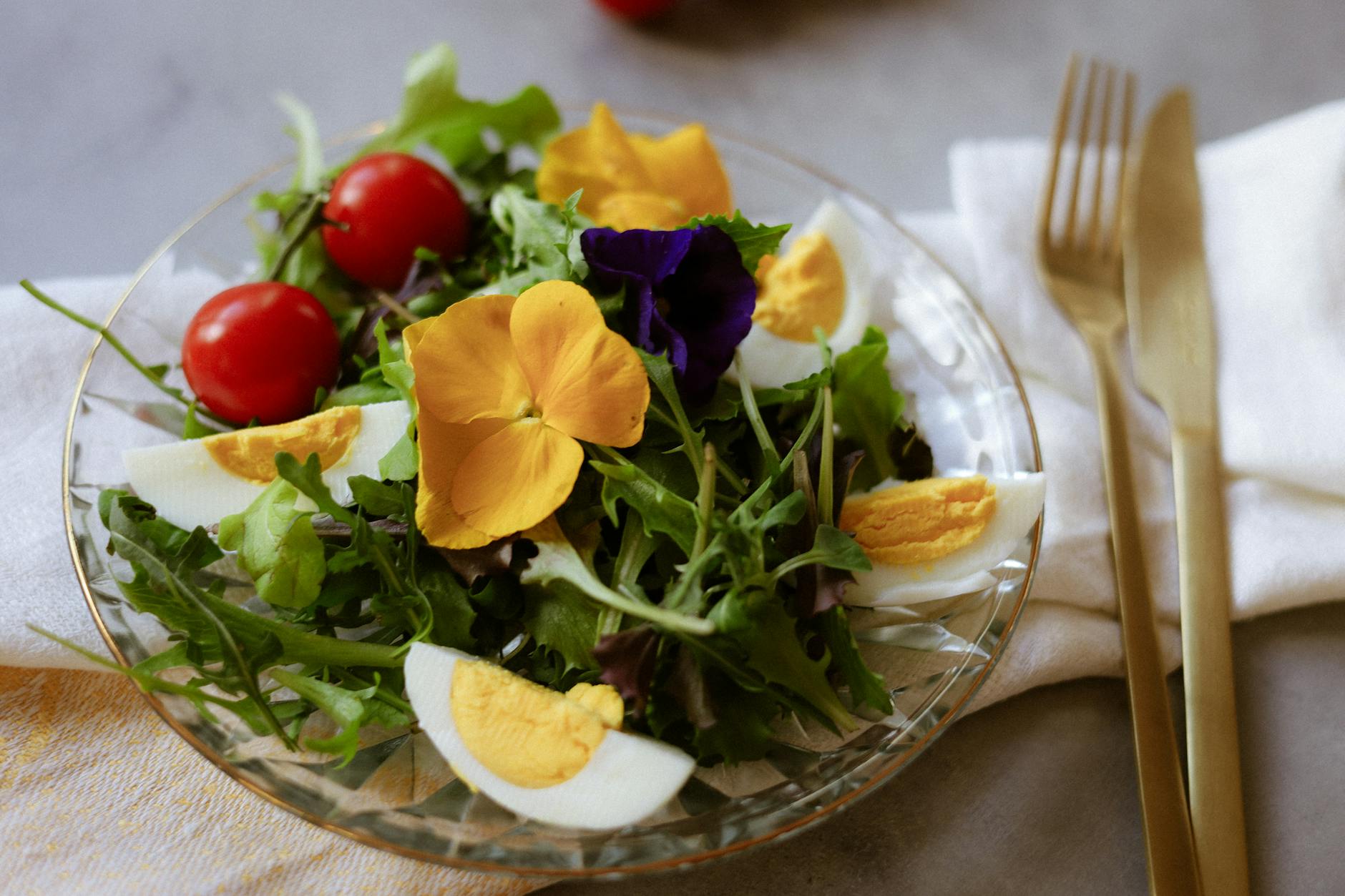 fresh salad with edible flowers and eggs